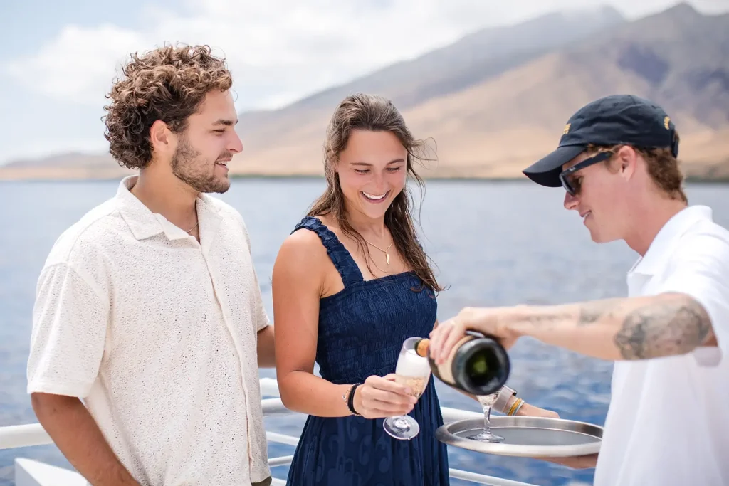 Guests enjoying champagne on a Private Yacht Cruise with scenic views on Maui