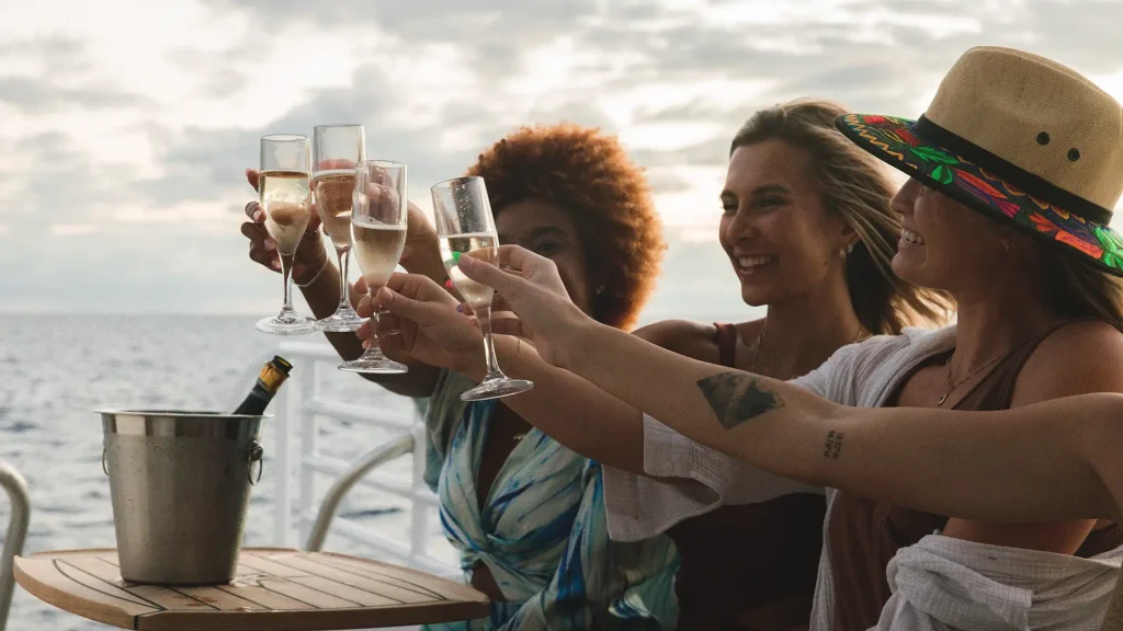 Guests enjoying a day-end sunset sail aboard a private catamaran charter