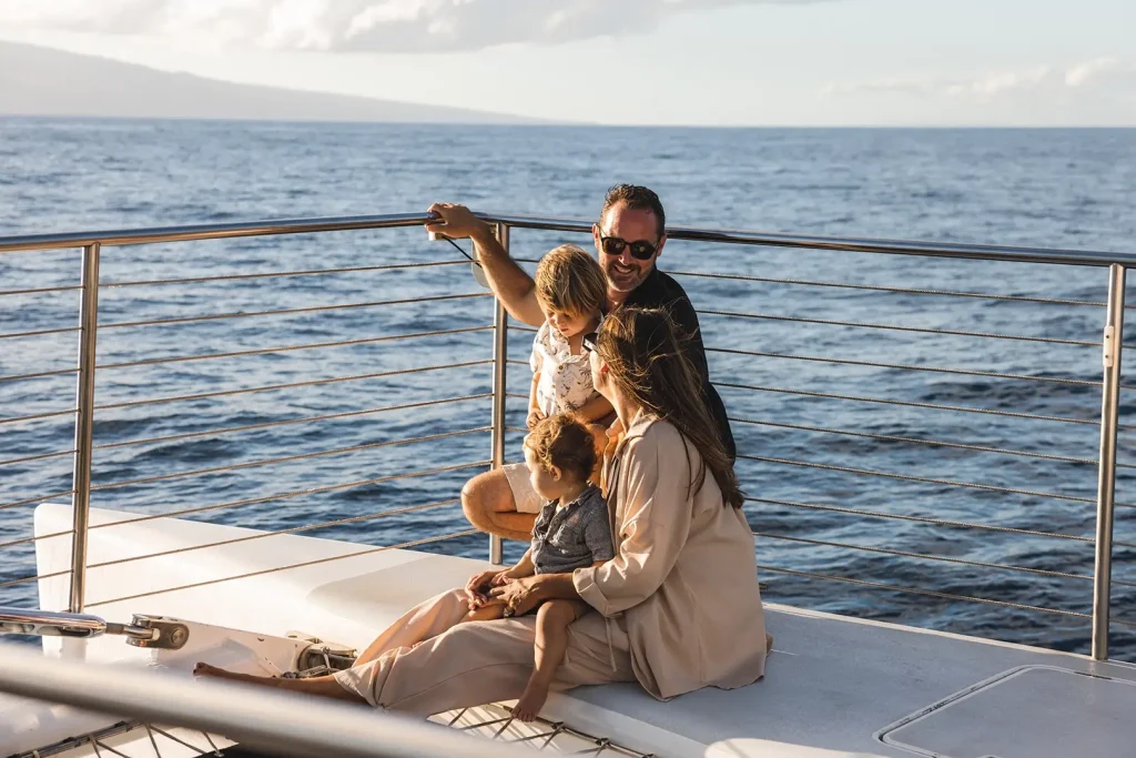 A family enjoys the serene ocean view while seated on a boat, with gentle waves