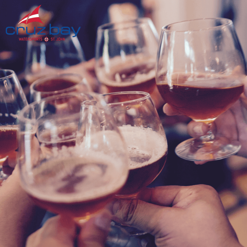 Group Toasting With Glasses Of Beer, Featuring Cruz Bay Watersports Logo In The Background.