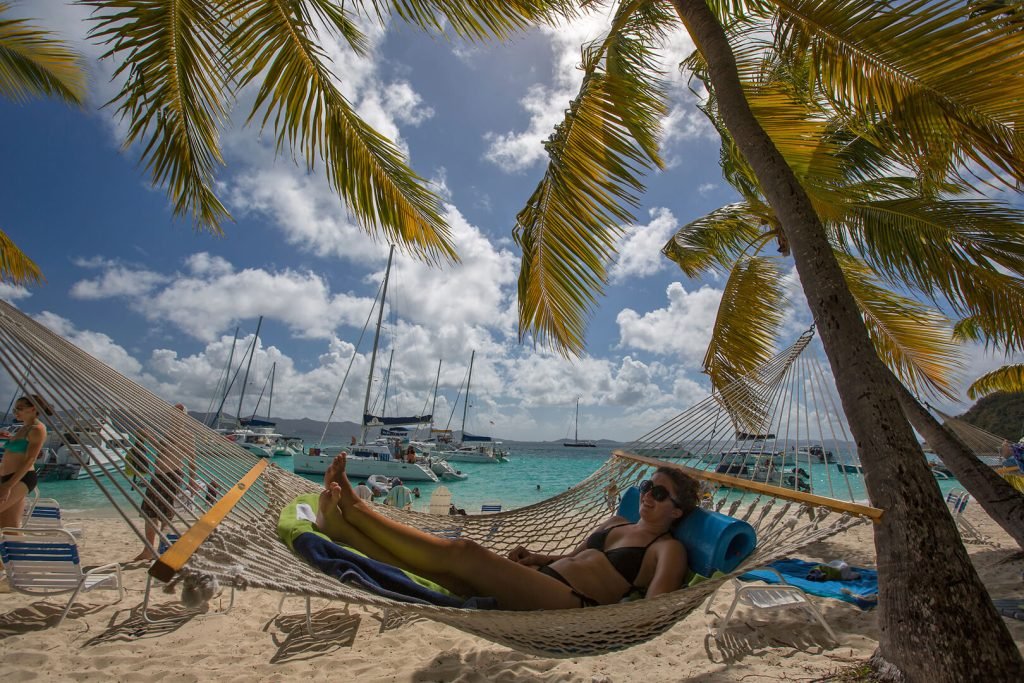 Person In Hammock On White Bay Beach With Sailboats Near Soggy Dollar Bar, Bvi