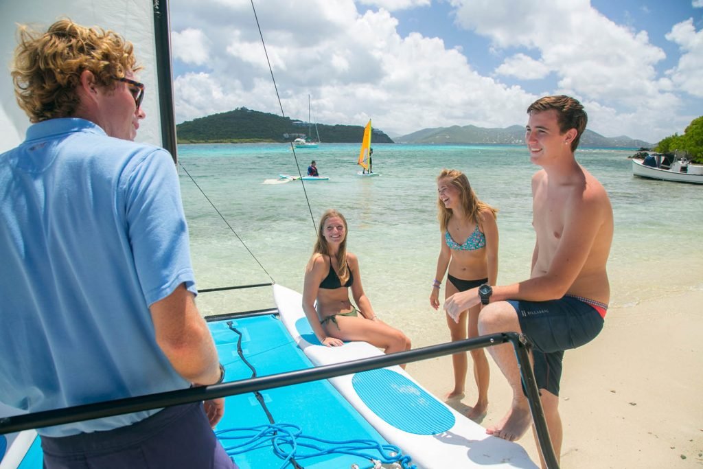 Group enjoying sailing and paddleboarding with Cruz Bay Watersports in US Virgin Islands waters.