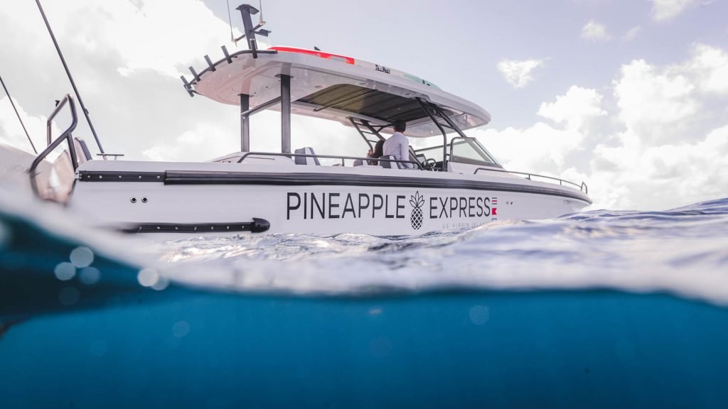 A Split-Level View With The Underside Of Water And A Boat Named &Quot;Pineapple Express&Quot; Above The Surface.