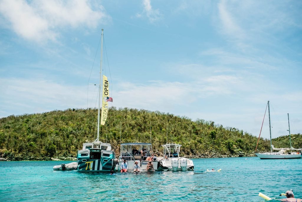 Pizza Pi sailboat pizzeria floating in Christmas Cove, US Virgin Islands, serving wood-fired pizza.