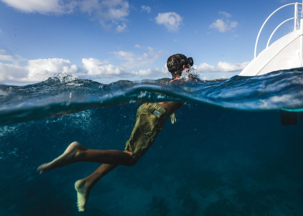Person snorkeling near boat during a sail and snorkel tour.