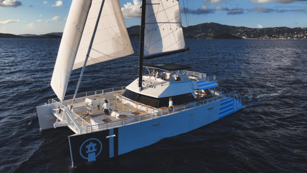 Flying Frenchman catamaran sailing at sunset from Frenchman's Reef, US Virgin Islands.